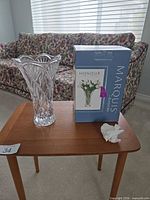 Vase standing next to original box on table