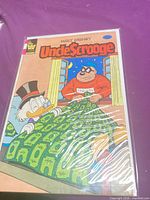Front cover of bagged Uncle Scrooge comic showing characters and publisher markings