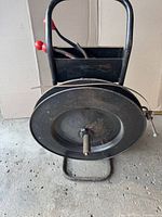 Front view of steel strapping cart with banding coil