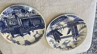 Both Johnson Bros blue & white London landmark plates side by side