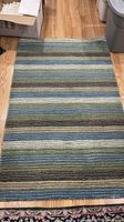 Top view of striped Pier 1 Imports area rug on floor