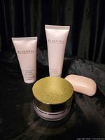 Front view showing two lotion tubes, soap, powder jar