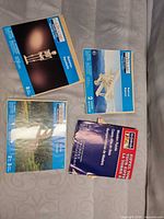 Four boxed wooden model kits displayed