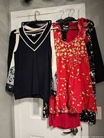 Multiple garments hanging on door