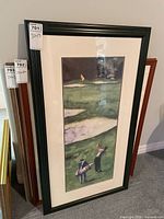 Full view of framed golf print standing against wall