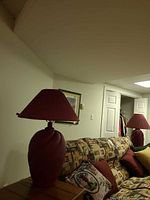 Table lamp on side table behind sofa