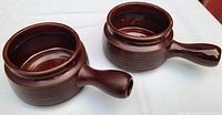 Pair of brown stoneware soup bowls with side handles