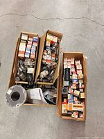 Three cartons filled with boxed and loose vacuum tubes