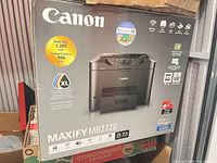 Front of boxed Canon MAXIFY MB2720 printer showing model, functions and XL ink compatibility sticker