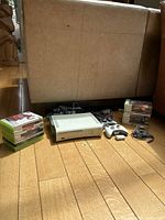 Bundle overview showing console, cables, controllers, two stacks of games