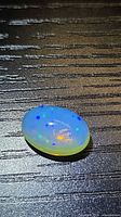Top view of oval opal showing play-of-color
