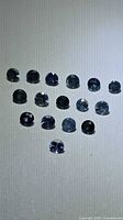 Cluster of small round blue sapphires on neutral background