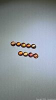Eight small round cabochon sapphires in two rows