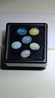 Six opals in display box frontal view
