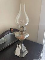 Full view of glass oil lamp on table