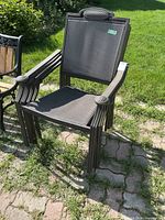 Front view of one chair showing frame, mesh seat/back, arm shape