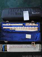 Disassembled flute pieces and Pad-Saver in open case showing exterior ‘Gemeinhardt’ logo