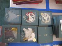 Top view of six Lenox ornaments in original boxes, showing their shapes and packaging