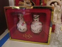 Two snowmen Lenox porcelain ornaments in original box with red background and gold trim.