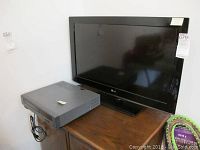 LG 32-inch TV and Daewoo VHS VCR on wooden surface, both unplugged and untested.