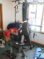 Full view of the Bowflex Extreme home gym showing padded seat, backrest, various pulleys and cables attached to resistance rods