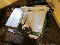 Top view of Hitachi table saw showing blade and work surface with attached guide rail.