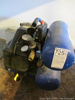 Full view of the Cummings 2.5 HP twin tank air compressor showing motor housing and blue twin tanks.