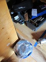 Overhead view of Siecor case, wire stripper, tool components and cable bucket on wooden floor