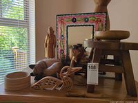 Group shot of all wooden decor pieces and mirror