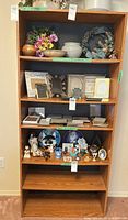 Full view of oak veneer bookcase with five shelves