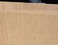 Close-up of sealed cardboard shipping box containing the comforter set