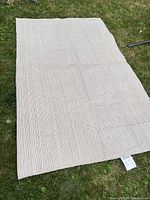 Full view of rug laid flat on grass
