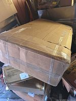 Sealed cardboard box containing mattress topper