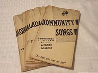 Front covers of multiple Community Songs booklets showing branding and graphics
