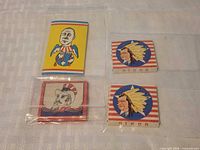 Four rolling paper booklets in plastic sleeves on table