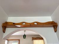 Full view of pine wall shelf spanning archway