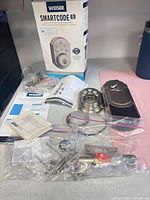 Complete Weiser SmartCode 5 deadbolt set with parts, manuals and box