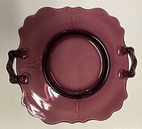 Top view showing entire amethyst glass plate, scalloped rim and handles