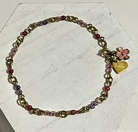 Full view of bracelet laid flat showing beads and charms
