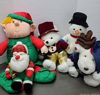 Group shot of all five holiday plush items