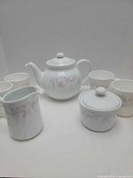 Full set showing teapot, sugar bowl, creamer and four of six mugs