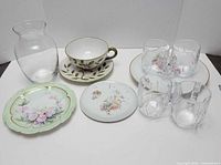 Full lot showing vase, teacup with saucer, accent plate, trivet, four mugs
