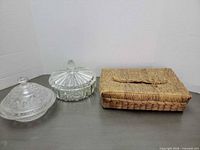 Overall lot showing straw basket and two covered glass dishes