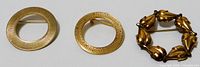 All three gold-tone brooches front view