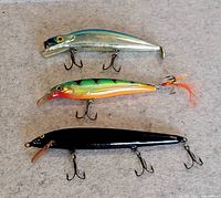 Three lures laid out on fabric background