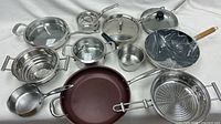 Full set laid out showing pans, pots, lids, steamer