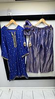 Full set: kurta, pants, pouch displayed on hangers