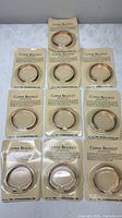 All ten blister-packed copper bracelets laid out