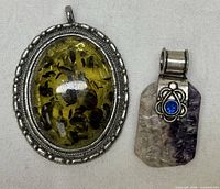 Front view of both pendants showing stones and settings