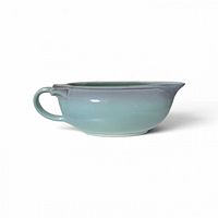 Side profile of gravy boat showing handle, spout and glaze coloration